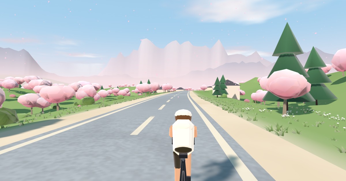 OpenCycle rider on an open road through a valley of pink cherry-blossom trees, with pale mountains ahead