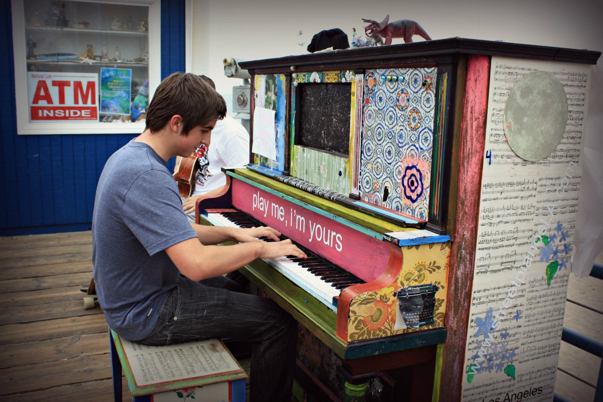 Alex playing a painted outdoor piano